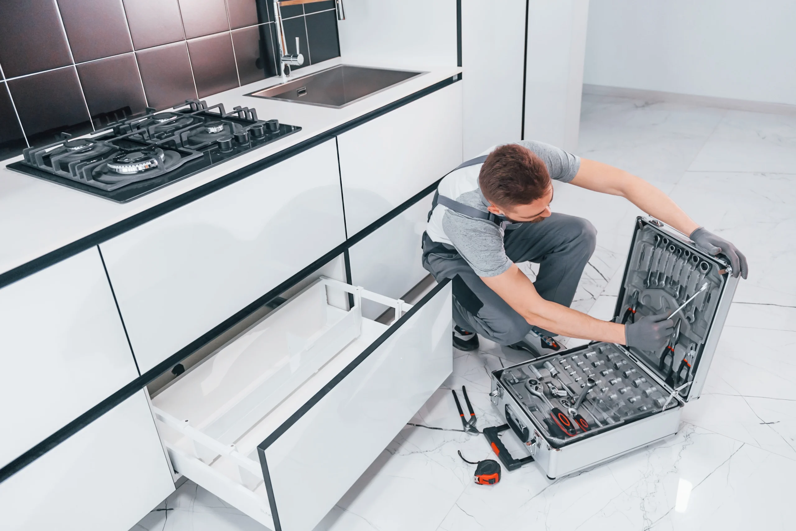 young-professional-plumber-in-grey-uniform-using-e-